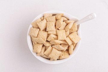 Corn pads in clay bowl on light white background