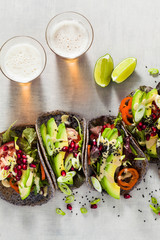 Gluten-free vegan tacos from black bean  with tomato and avocado salad  with tahini sauce and...