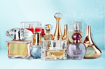 Aromatic Perfume bottles on white wooden desk at wooden