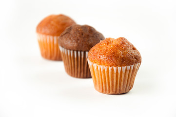 Close-up of lemon and chocolate muffins isolated on white background, selective focus.