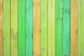Wooden table or planks fence, green-orange background, texture
