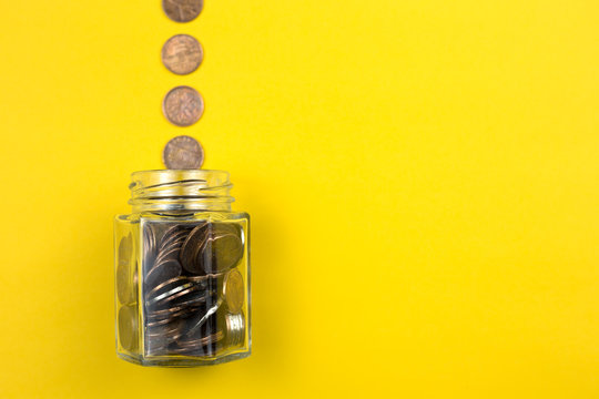 Coins with glass jar for money saving financial