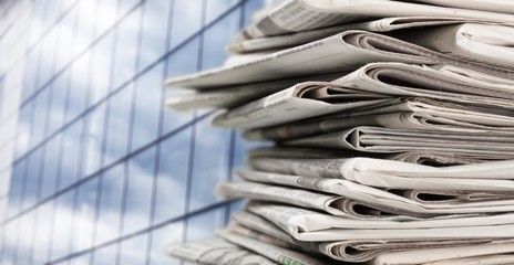 Pile of newspapers on white background