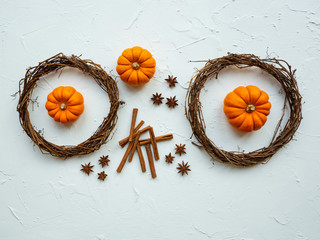 Three mini pumpkins with two virginia creeper wreaths, cinamon sticks and star anise