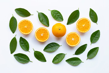 Oranges and green leaves on white background.