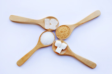 Various types of sugar on white background.