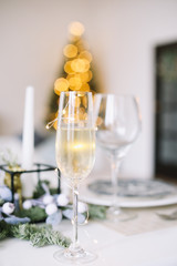 A glass of champagne. Serving a festive table. New year decorations. Christmas and  New Year concept