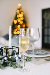 A glass of champagne. Serving a festive table. New year decorations. Christmas and  New Year concept