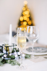 A glass of champagne. Serving a festive table. New year decorations. Christmas and  New Year concept