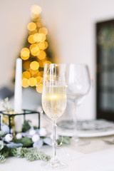 A glass of champagne. Serving a festive table. New year decorations. Christmas and  New Year concept