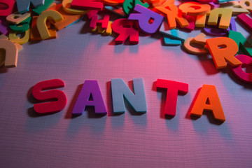 Children's word on wooden table: SANTA