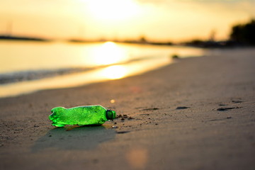 Plastic garbage, Dirty waste on beach in summer day. on the sunset.