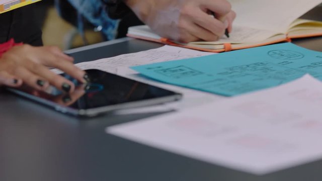 close up hands engineers developing software application sharing ideas diverse students designing mobile app brainstorming design interface solution using layout drawings in office meeting