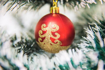 Red ball with golden on christmas tree