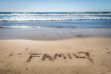 Family Written in Sand at Beach
