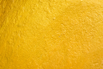 Golden concrete texture. Gold color painted on cement wall for background and wallpaper
