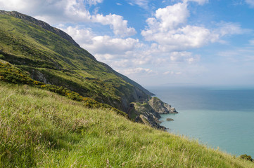 Fototapeta na wymiar View over cliffs of Co. Wicklow, Ireland, between Greystones and Bray showing the Irish sea and rail tunnels cut into the sides of the rocky cliffs.