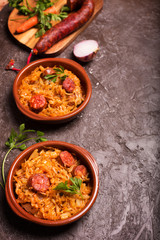 Bigos, a traditional Polish dish with cabbage on brown background