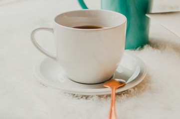 LIFESTYLE COFFEE MUG IN A GREEN COTTON NEUTRAL BACKGROUND WITH COPPER ROSE GOLD DETAILS 