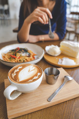 Chilling day of happy woman in coffee cafe shop with hot latte and sweet white cake