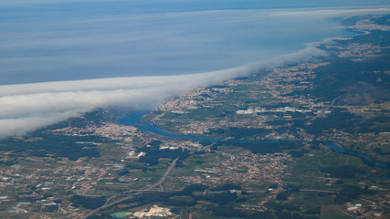 Fototapeta na wymiar Aerial shot from plane over Braga district in Portugal showing cities of Esposende, Apulia and Fao and the Cavado river