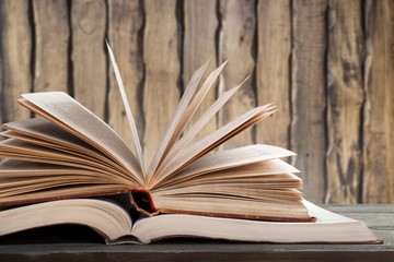 Big opened book with sparkles on background