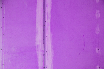 wall of hardboard with traces of glue and paint. toned