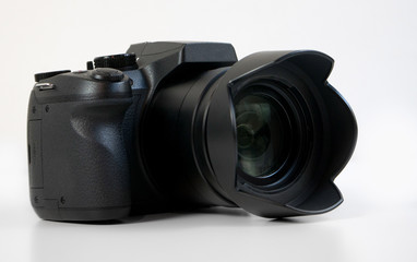 DSLR-Style Digital Camera with lens, isolated on white background.