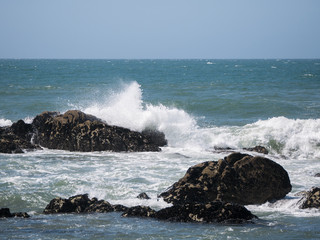 Waves batter rocks on the rocky coast in Northern Portugal in the summer.