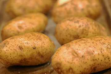 Potatoes with oil and salt being prepared for dinner