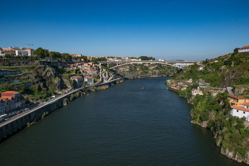 Wide angle view over Douro river in Porto, Portugal on bright sunny day with blue sky