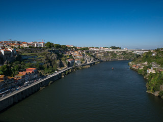 Fototapeta na wymiar View along the Douro River in Porto, Portugal over Douro valley on a sunny summer day with blue sky