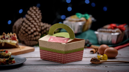 Cardboard Packed Christmas Cake on wooden white table