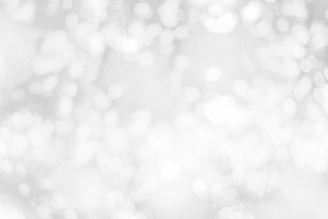 Abstract glamorous white and silver bokeh lights glitter sparkle. Defocused background have luxury golden color party invite for birthday, anniversary, holliday, new year xmas or snow christmas blur.