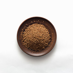 Buckwheat cereal grains on the white background, top view, flat lay