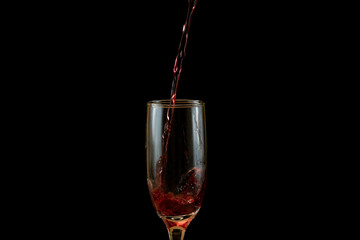 Pouring delicious red wine into glass
