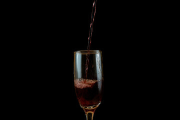Pouring delicious red wine into glass