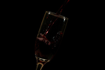 Pouring delicious red wine into glass