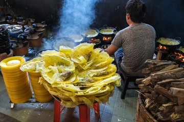 Banh xeo, Vietnamese traditional street food yellow crispy rice flour cake. Sizzling cake, named for the loud sizzling sound it makes when the rice batter is poured into the hot skillet