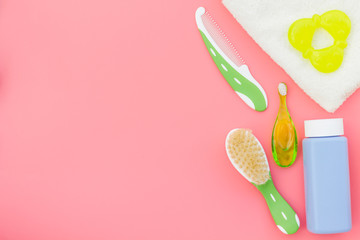 Hygiene items for the child. Bath accessories on pink background top view copy space