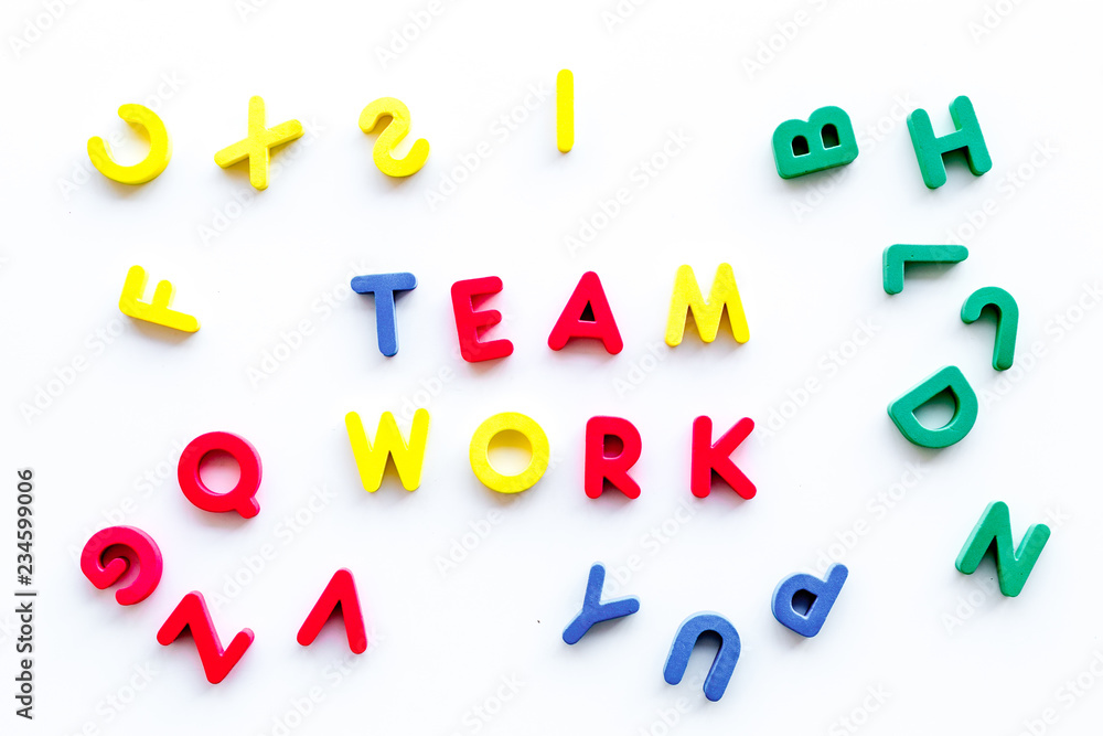 Poster teamwork training concept. text teamwork lined with colored letters in frame of toy letters on white