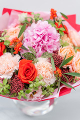 European floral shop. Bouquet Mixed beautiful flowers on wooden gray table. Nice garden flowers in the arrangement , the work of a professional florist.