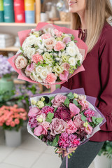 European floral shop. Two Bouquet of beautiful Mixed flowers in woman hand. Excellent garden flowers in the arrangement , the work of a professional florist.