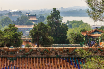 Fototapeta na wymiar The temple roof and Beijing city skyline from the top of Buddhist Yong'An (Temple of Everlasting Peace) in Beihai Park, Beijing, China