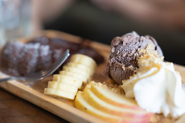 Chocolate ice cream with topping fruit.