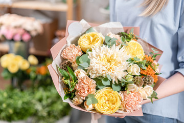 European floral shop. Bouquet of beautiful Mixed flowers in woman hand. Excellent garden flowers in the arrangement , the work of a professional florist.
