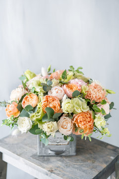 Fototapeta Bouquet of fresh spring flowers on gray wall background. Floral arrangement in vintage metal vase. flower shop, florist work