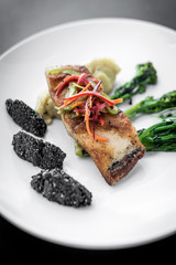 red snapper fish fillet with vegetables and black sesame rice