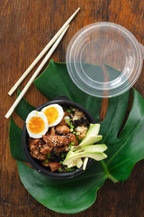 Two poke bowl fried rice chicken meat eggs box top view Asian take away food