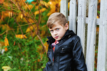 Portrait of a boy in a black leather jacket for a walk